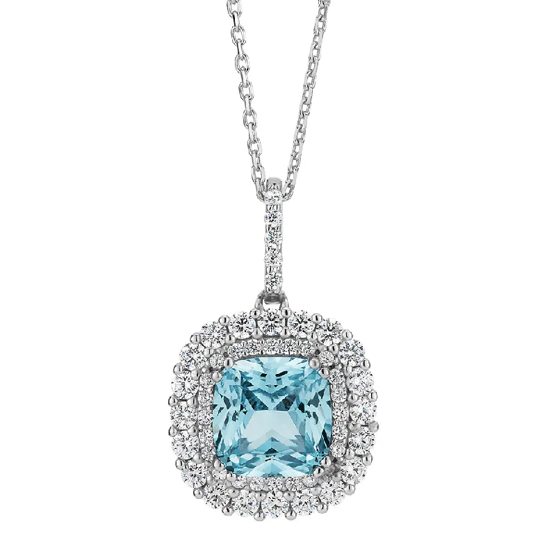 Long drop necklaces-Halo necklace with blue topaz simulant and 0.73 carats* of diamond simulants in sterling silver