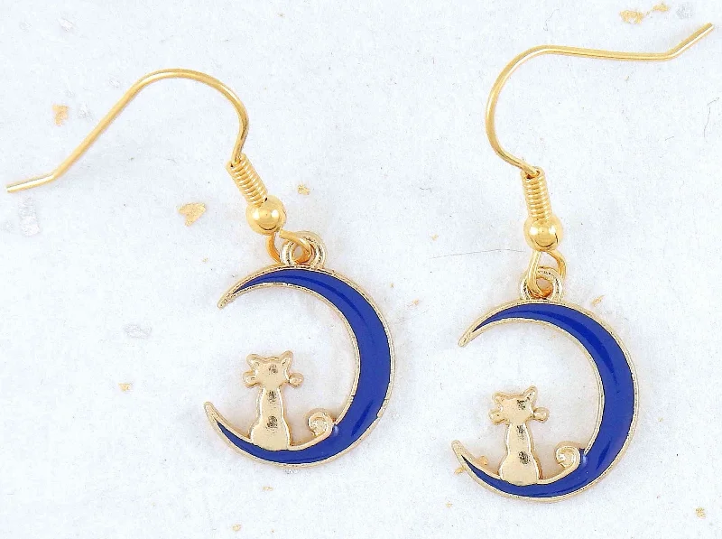 Short earrings with tiny gold cats sitting on blue enamelled moon crescents, gold-toned stainless steel hooks