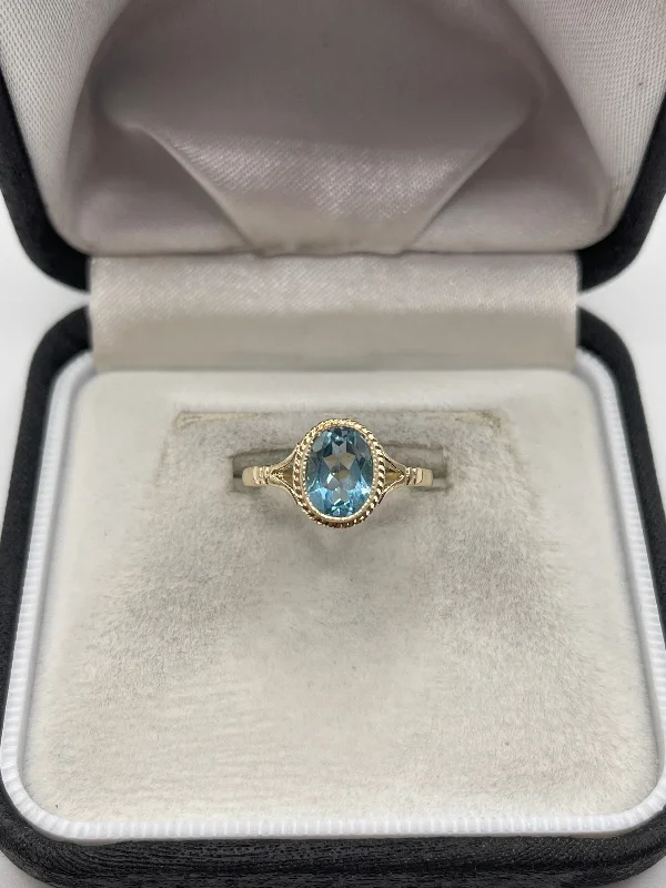 Blended metal rings-9ct gold blue topaz ring